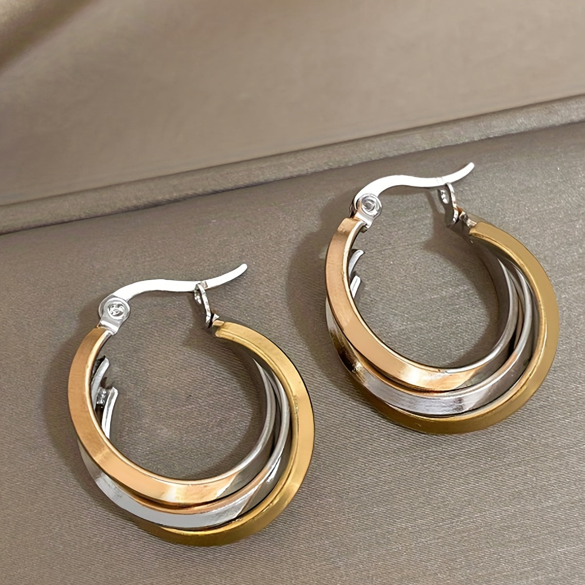 Multi-color twisted triple layered hoop earrings with a two-tone leverback design, perfect for adding a pop of color and style to any party, club, or vacation outfit. Give the gift of stunning jewelry to a loved one.