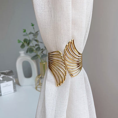 A pair of golden metal curtain clips shaped like angel wings, featuring a spring opening and closing mechanism. These hollow wing tiebacks are perfect for adding a touch of elegance to your living room, study, or bedroom curtains, enhancing your home