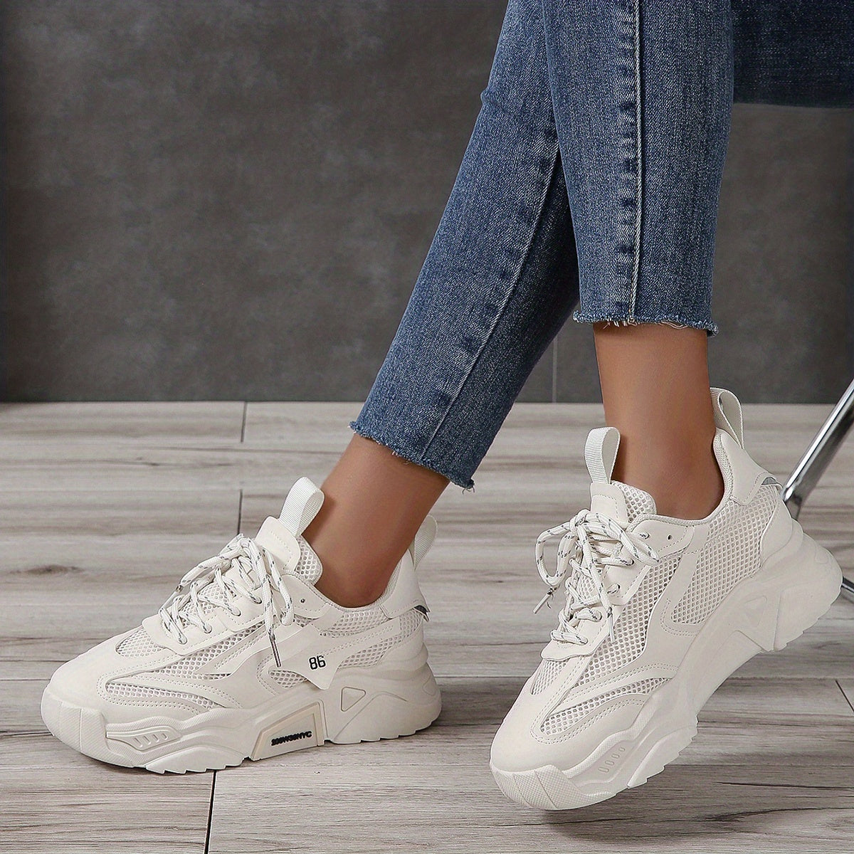 Solid color mesh sneakers for women with breathable lace-up design, versatile white low-top shoes.