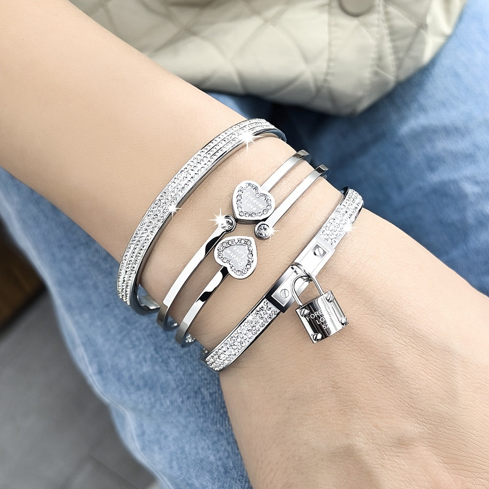 Stylish set of 3 stainless steel bracelets for women, plated in 18K gold with a heart-shaped pendant adorned with sparkling synthetic zirconia. The perfect luxury gift for weddings, parties, and Christmas, suitable for all seasons.