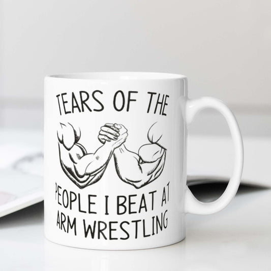 This motivational mug is perfect for arm wrestling enthusiasts. The ceramic coffee cup features a design that reads "Tears of the People I Beat" and is food-safe. It is ideal for use in the office, camping, or dining and requires no electricity to use.