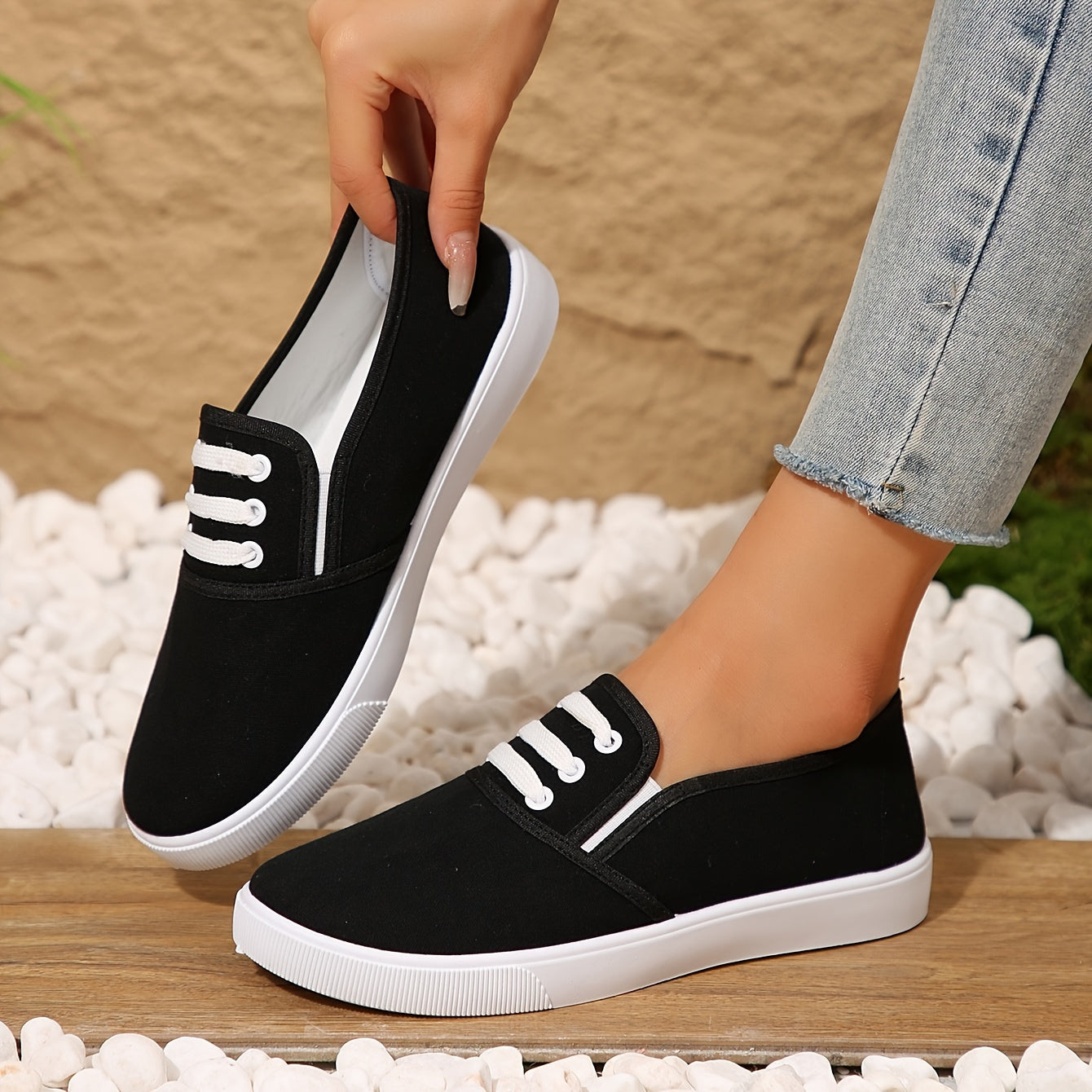 Lightweight white slip-on canvas sneakers for women with a soft sole and minimalist design.