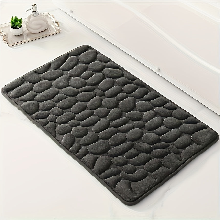 One piece of bath mat with embossed pebble pattern, highly absorbent and non-slip for bathroom use. Suitable for tub, toilet, and floor, made of machine washable polyester material. Dimensions are 59.94x39.88 cm.