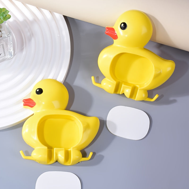 Wall-mounted toothbrush holder with cute duck design, waterproof plastic organizer with suction cup, no-drill installation, home decor.