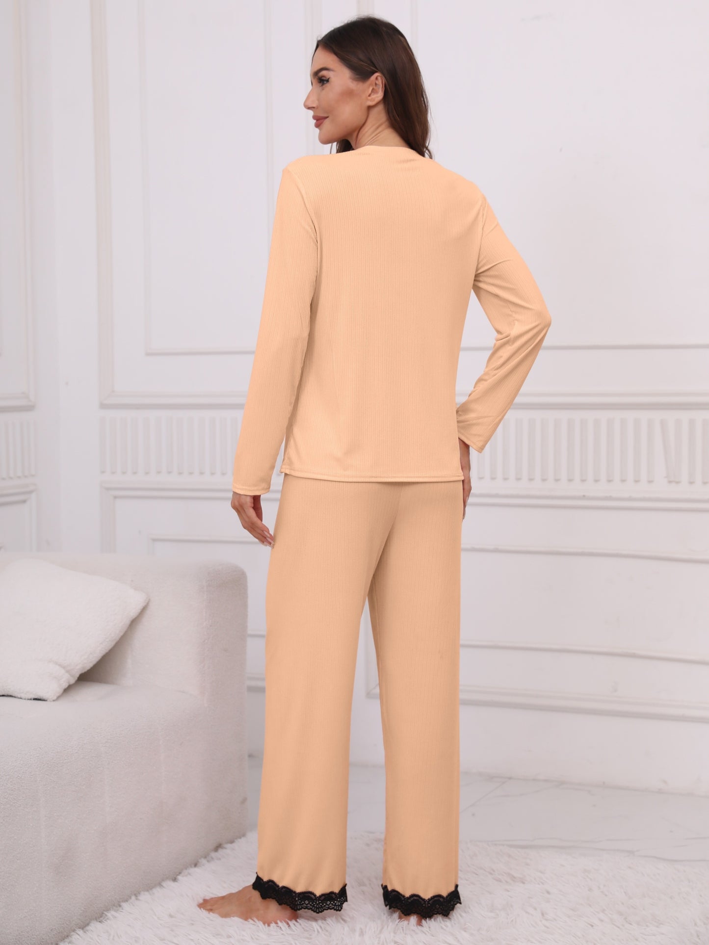 Women's lounge set with lace trim, crew neck top, and elastic waistband pants.