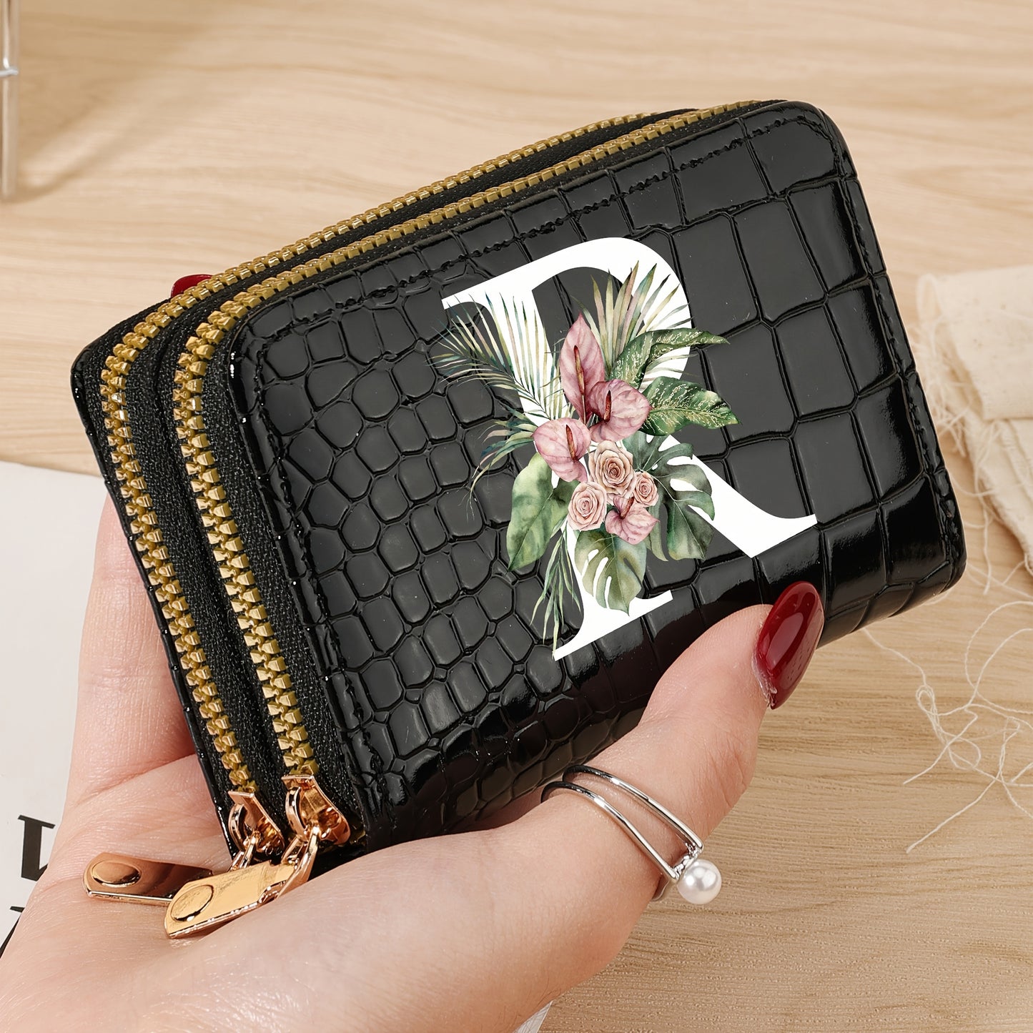 Women's credit card wallet with elegant floral letter print in black & white. Features large capacity, dual zipper, crocodile texture PU, lightweight design with nylon lining for everyday