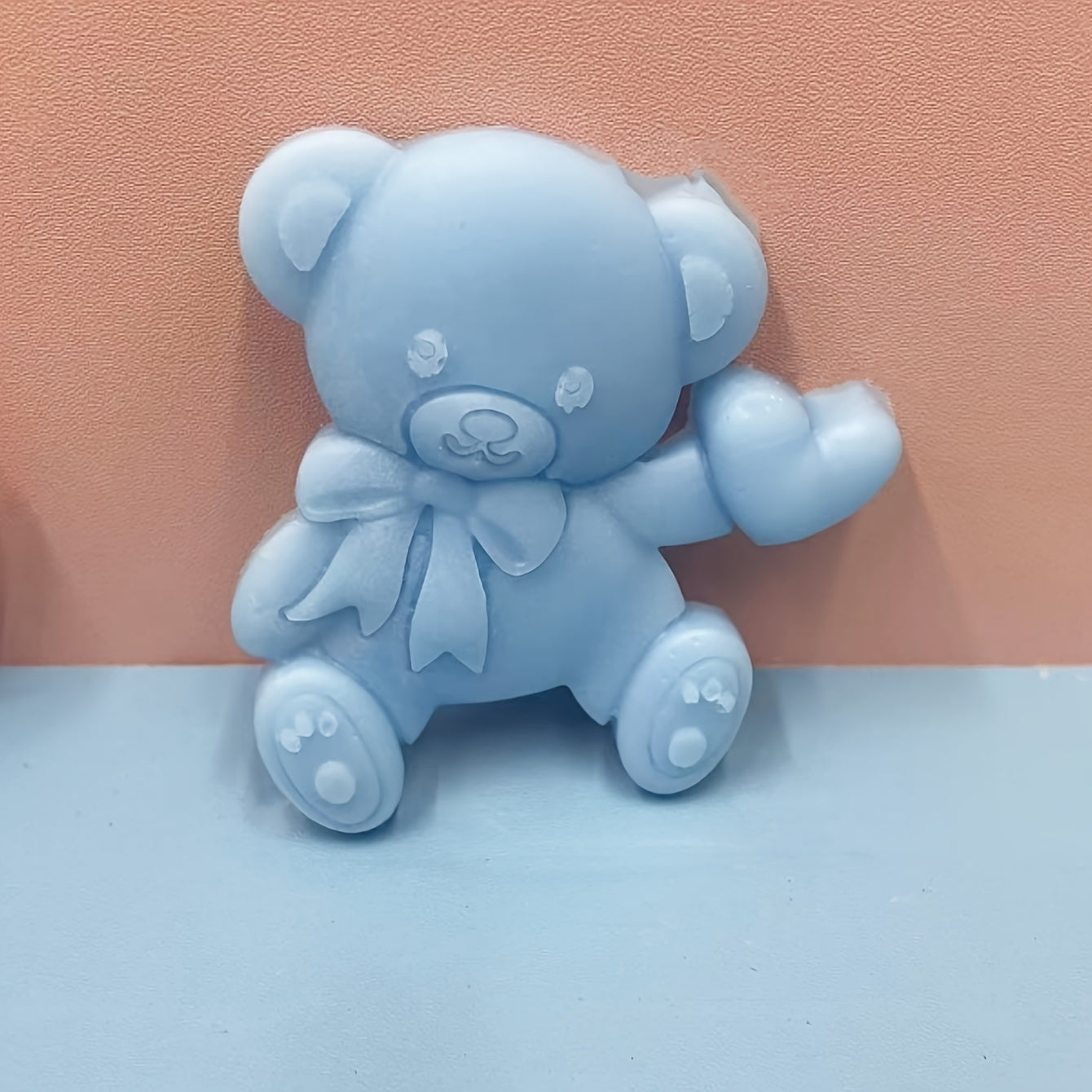 Silicone mold featuring a cute bear with a heart shape design, ideal for making mousse, fondant cakes, chocolates, and biscuits in the kitchen. This versatile tool can also be used for handmade candies, jellies, and puddings, as well as for creating drop