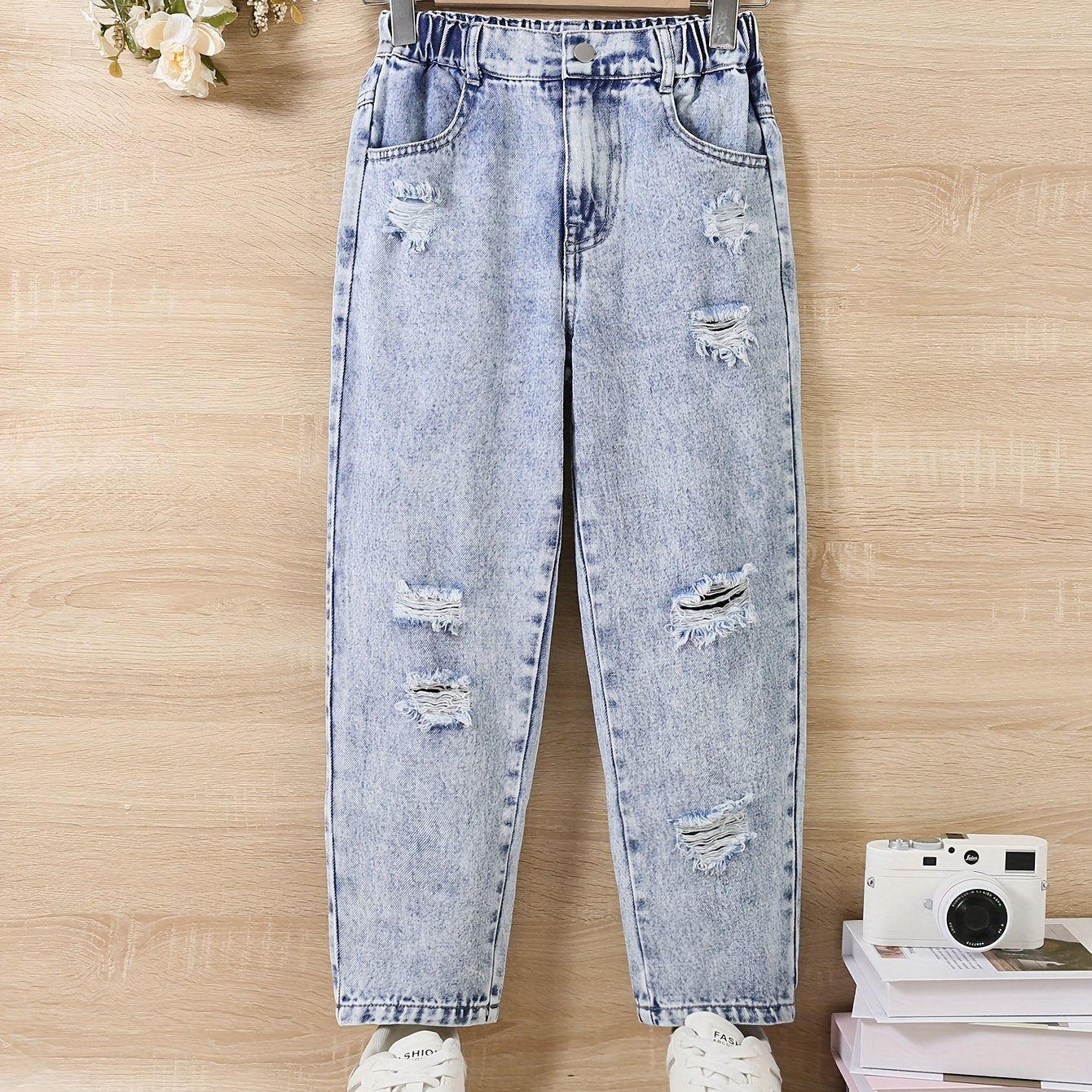 Girl jeans are stylish and versatile for all seasons, with specially designed holes for a trendy look.