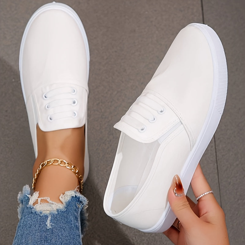 Lightweight white slip-on canvas sneakers for women with a soft sole and minimalist design.