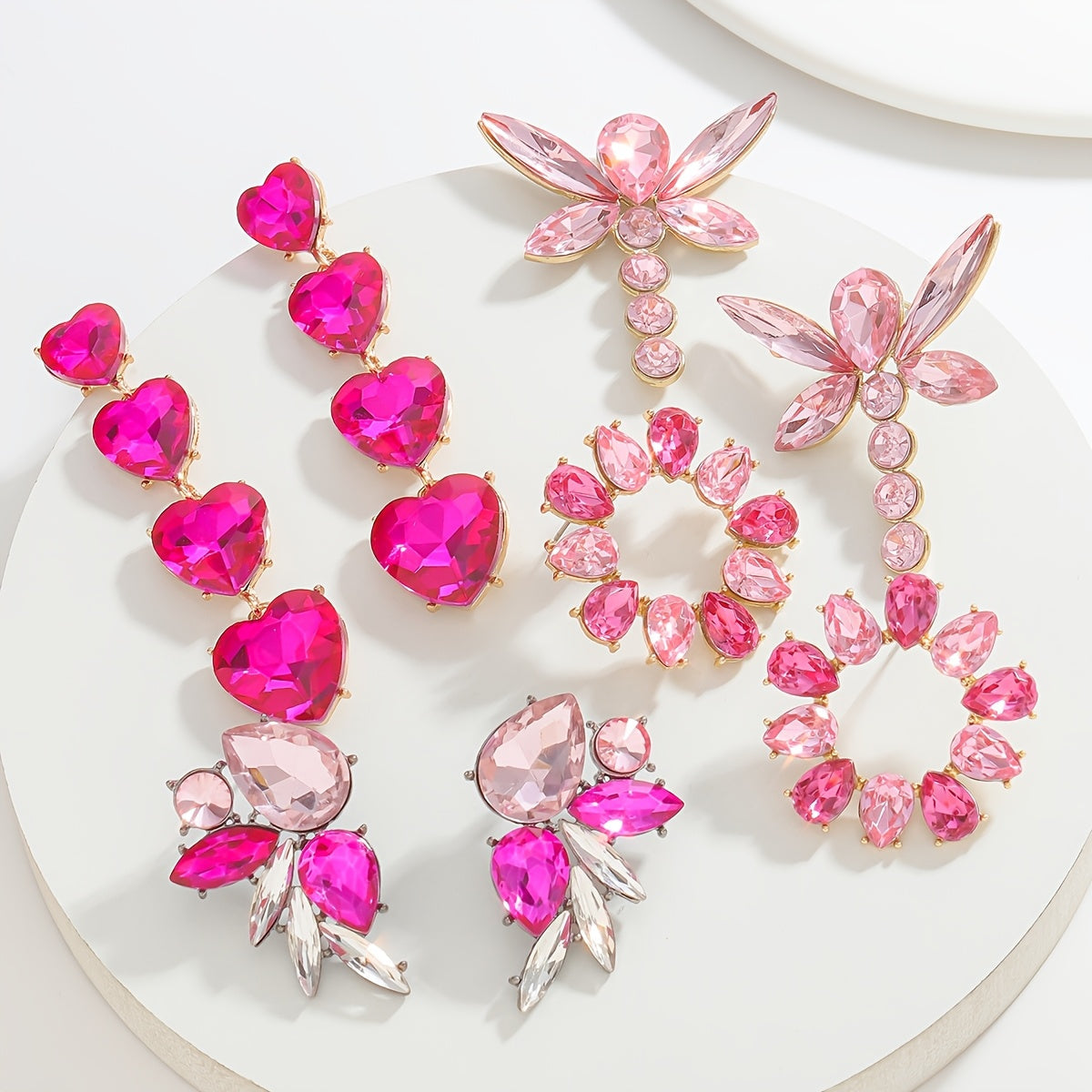 Add a touch of sparkle this Valentine's Day with our Pink Heart & Crystal Winged Drop Earrings. Featuring an elegant bling style, these earrings are made of Zinc Alloy with Stainless Steel Posts, perfect for weddings, parties, and gifts. The Round