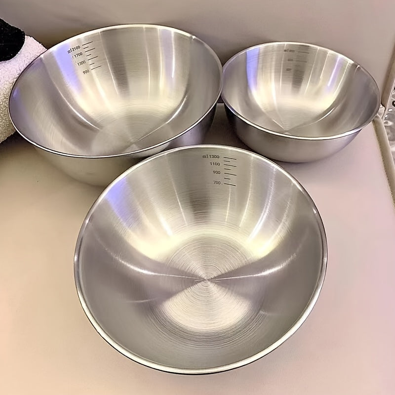 Set of 3 stainless steel mixing bowls with measurement marks, ideal for cooking and baking in kitchens and restaurants.