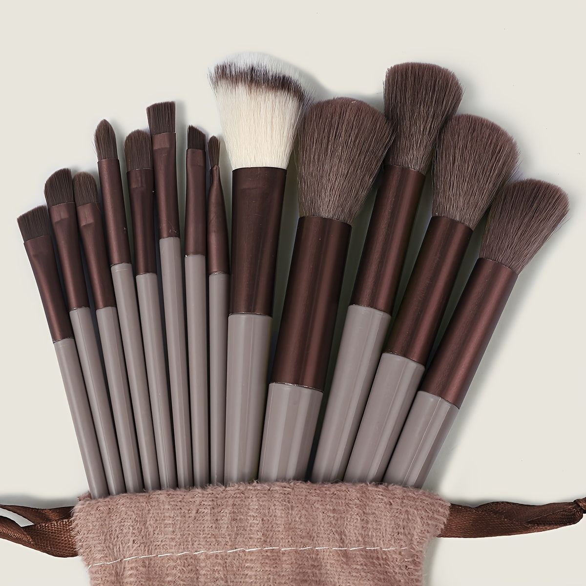 13-piece Makeup Brush Set with ultra soft, quick-dry bristles and matching fabric storage bag. Ideal for beauty enthusiasts.