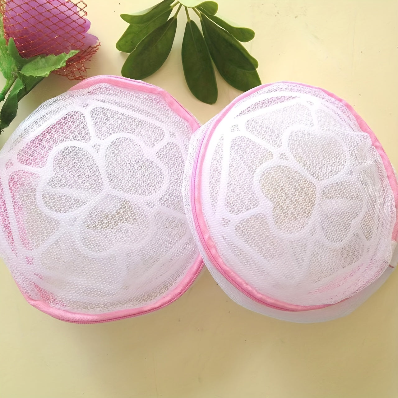 Pink zipper polyester mesh laundry bag, machine wash safe, anti-deformation for delicates and underwear, hexagonal pattern, laundry room accessory.