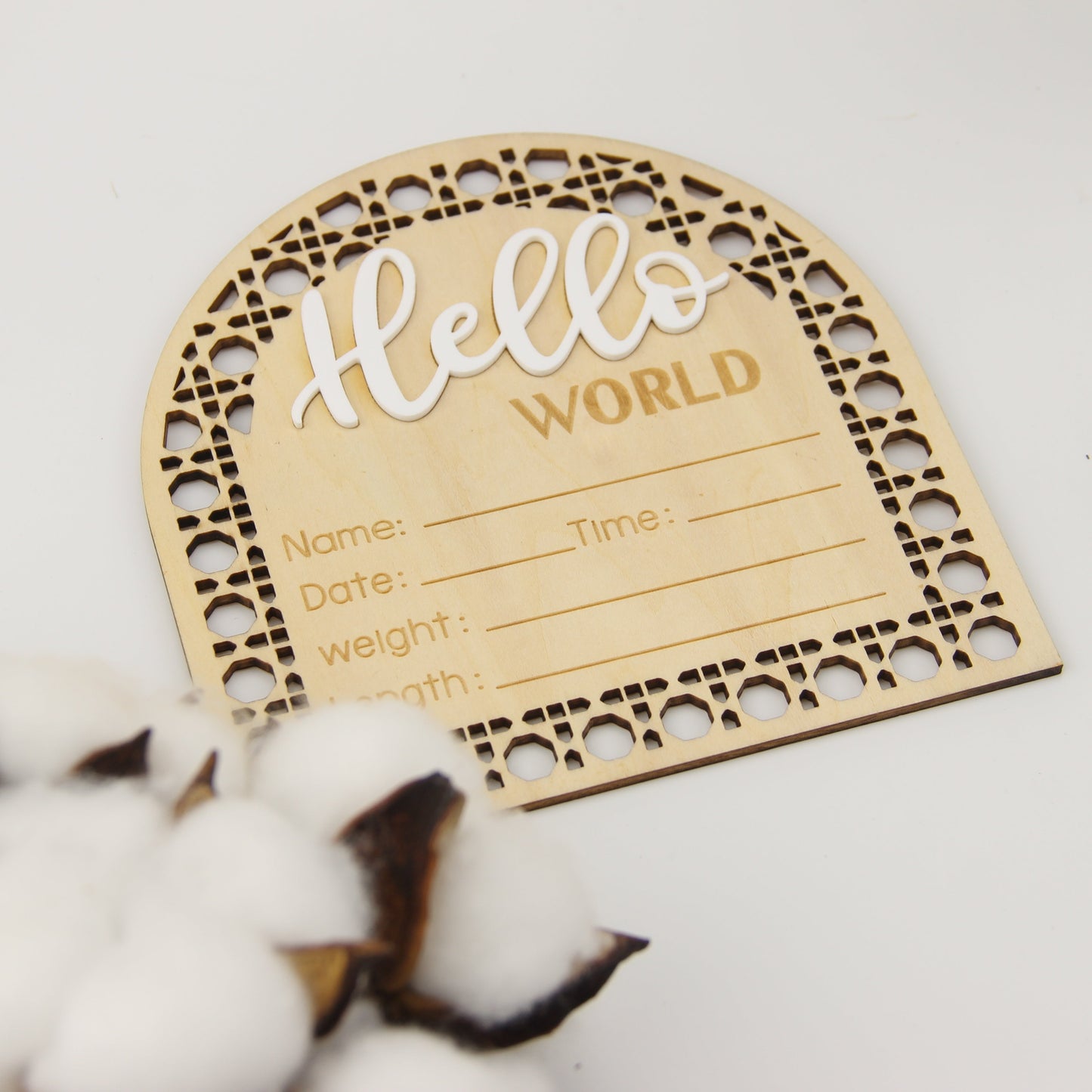 Wooden birth announcement plaque in fan-shaped design, featuring "Hello World" message. Perfect for photo props, this engraved keepsake plaque measures 13.97cm and includes fields for birth details. In a beautiful apricot color, this plaque is suitable