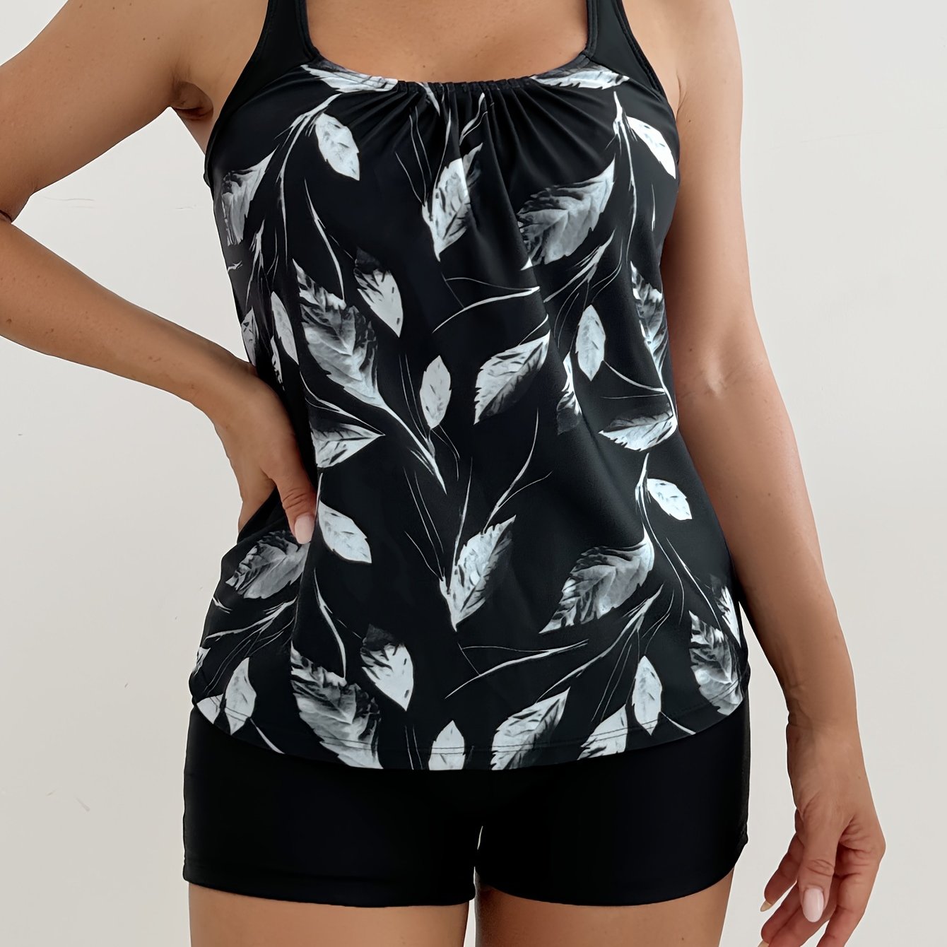 Black tankini set with random print tank top and black boxer shorts, 2 pieces.