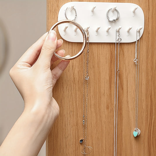 Wall mounted jewelry storage rack, white plastic. Perfect for gift or home decor in any room.