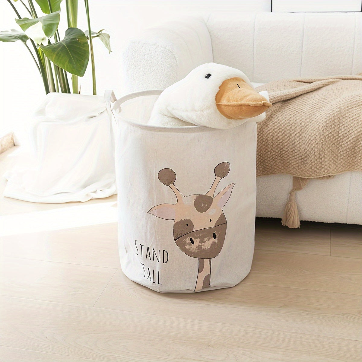 Collapsible fabric hamper with giraffe design, handles, and versatile storage for ages 12-14.