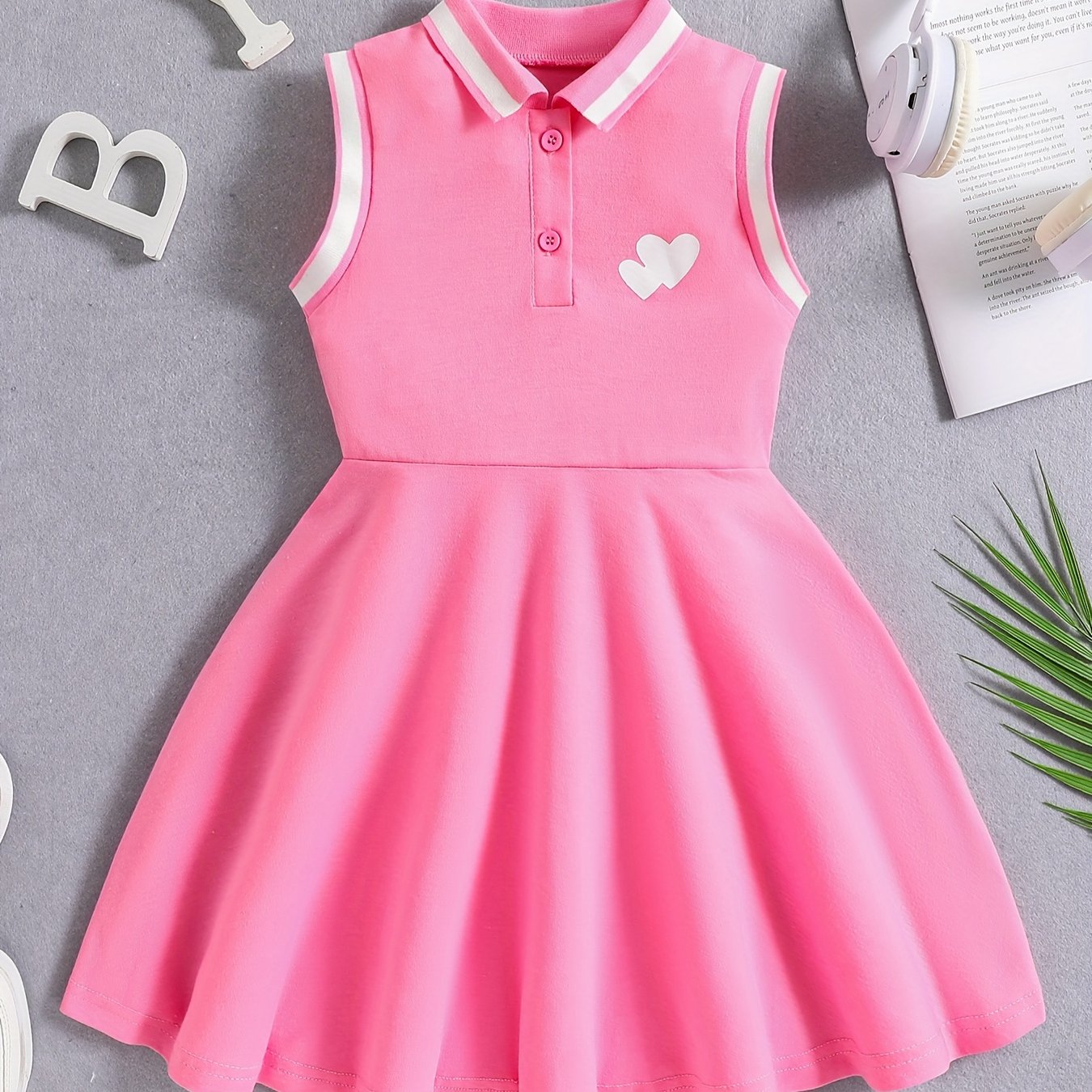 Girls' Red Tennis & Athletic Dress in sporty elegance featuring breathable, sweat-absorbent polyester with stretch and sleeveless design with black lettering for sports and casual wear.