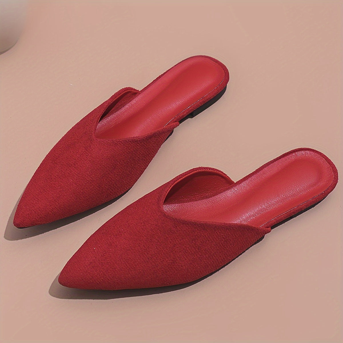 Stylish orange flat mules for women in plus sizes with pointed toe and slip-on design, perfect for casual wear.