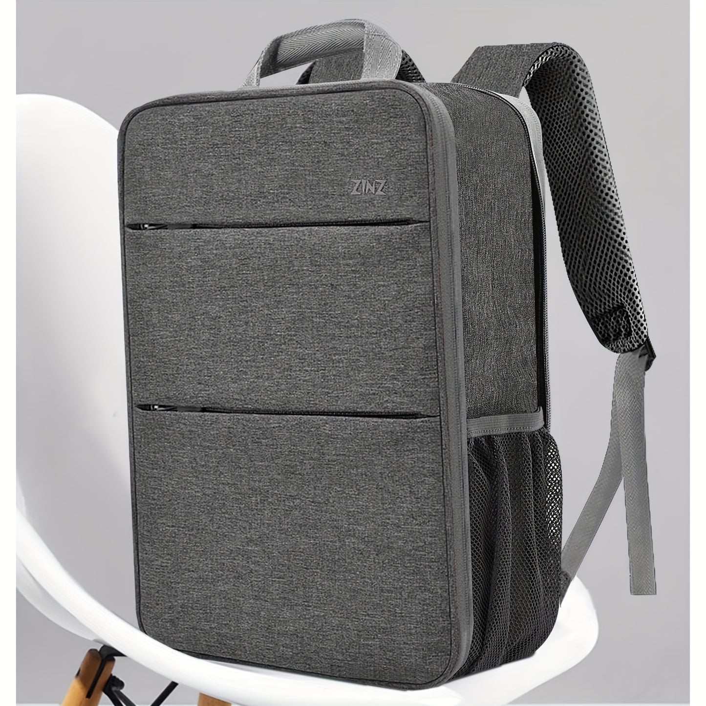 Ultra-slim laptop backpack for 35.56-40.64cm laptops, spill-resistant with durable polyester material.