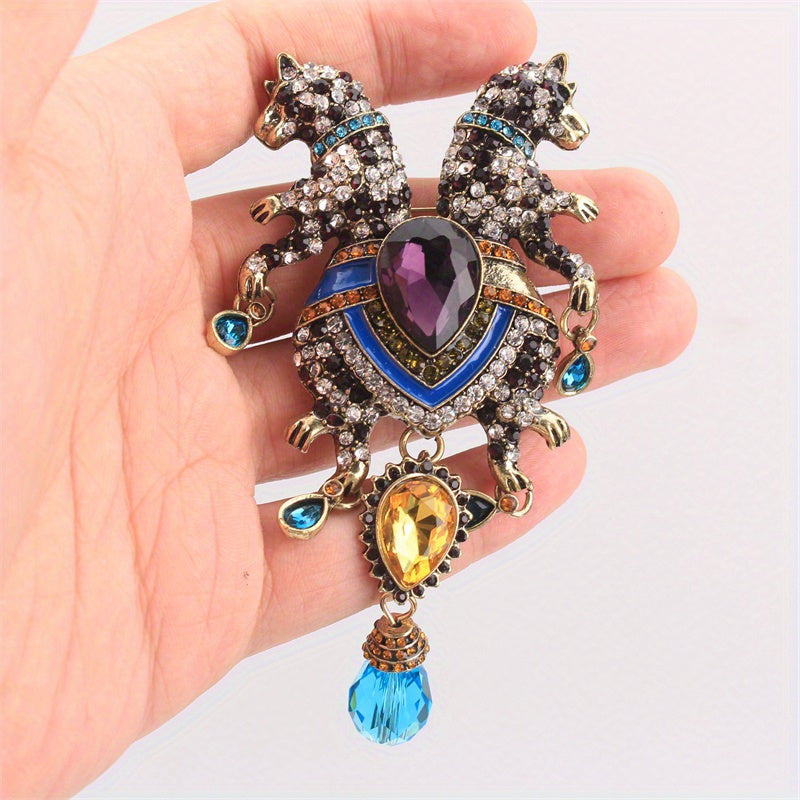 Luxurious and elegant, this animal brooch pin featuring a double-headed leopard with tassel is adorned with rhinestones. This novelty accessory has an irregular shape that enhances its charm. Perfect for adding a decorative touch to clothing, bags, and