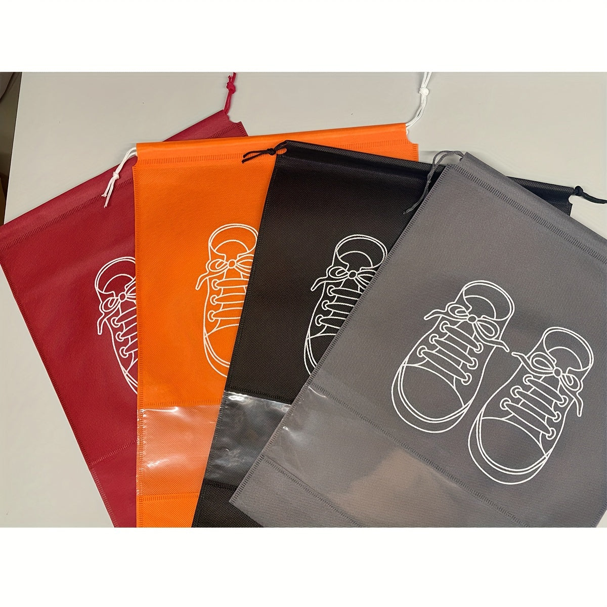 5 Portable shoe storage bags with drawstring made of waterproof, non-woven fabric for travel and closet organization.