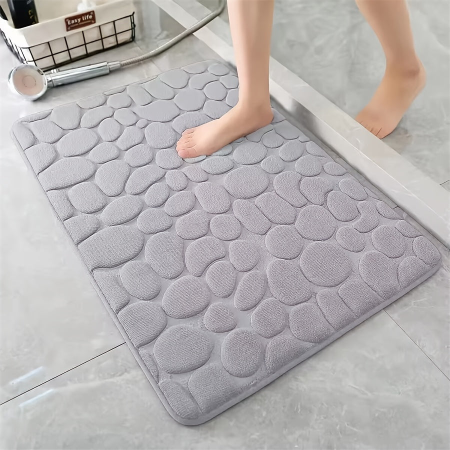 One piece of bath mat with embossed pebble pattern, highly absorbent and non-slip for bathroom use. Suitable for tub, toilet, and floor, made of machine washable polyester material. Dimensions are 59.94x39.88 cm.