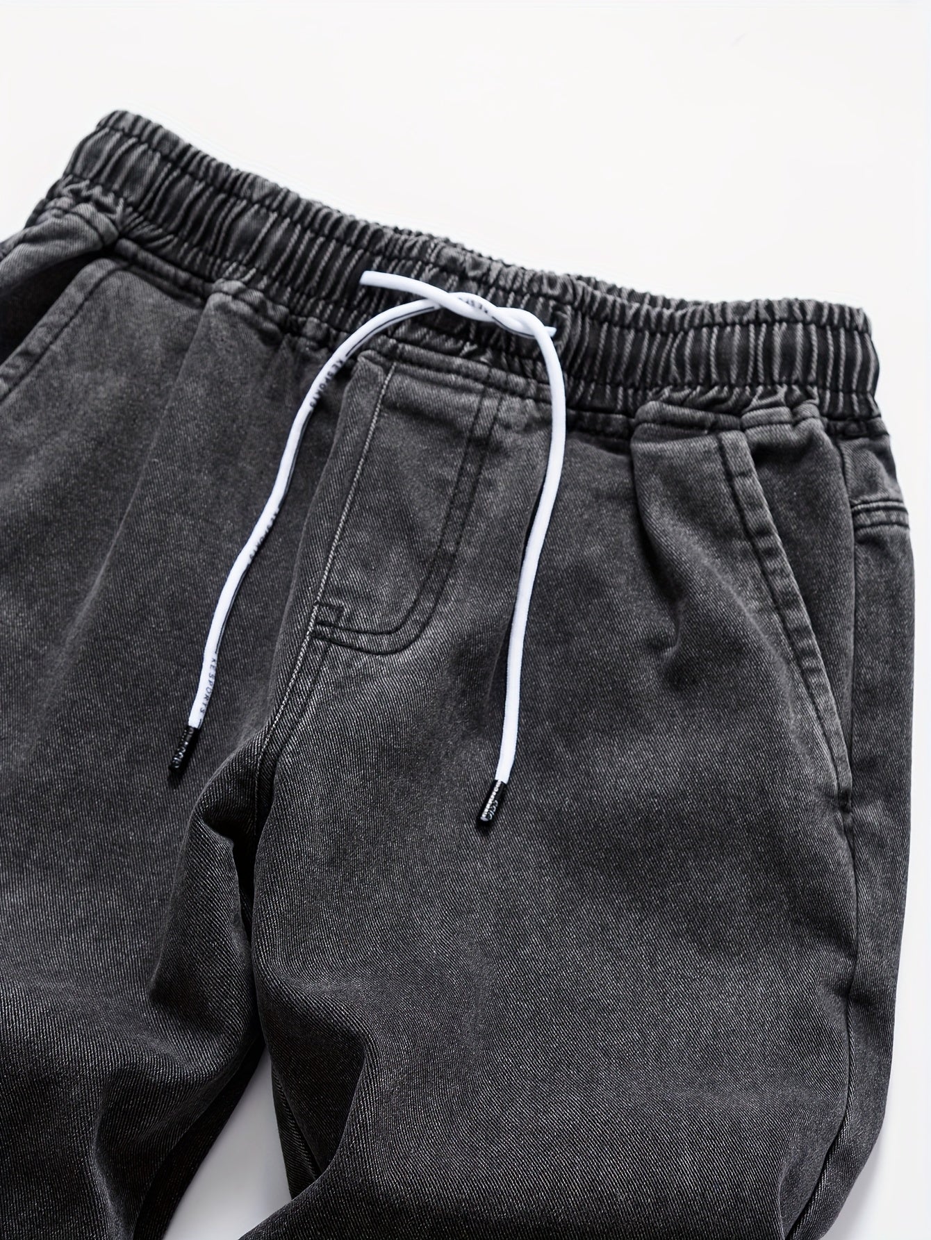 Mens' washed denim trousers with pockets and drawstring waist for outdoor activities