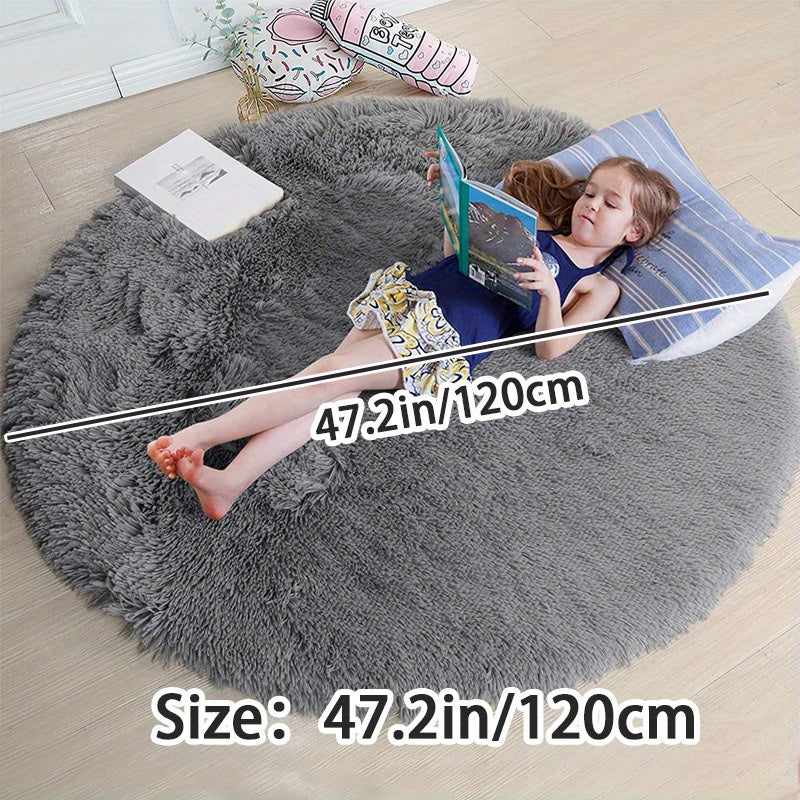 Soft shaggy round rug made of 100% grey polyester. This fluffy area rug is machine washable, fade resistant, and features a low pile tufted weave with PVC backing. Perfect for bedroom, nursery, and kids room decor. Great for gifts on Christmas