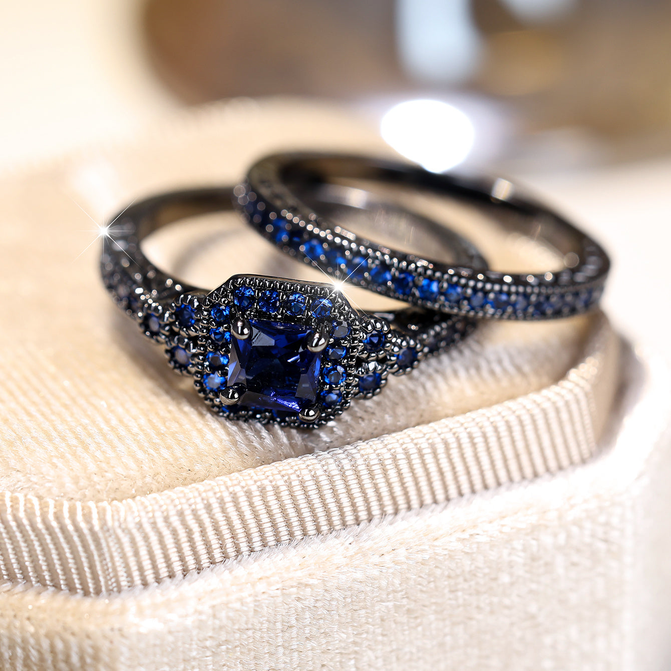 Set of 2 elegant promise rings featuring a halo ring with a dark blue zirconia stone and an eternity ring, perfect for engagement or wedding jewelry. Ideal for brides to enhance their evening party attire.