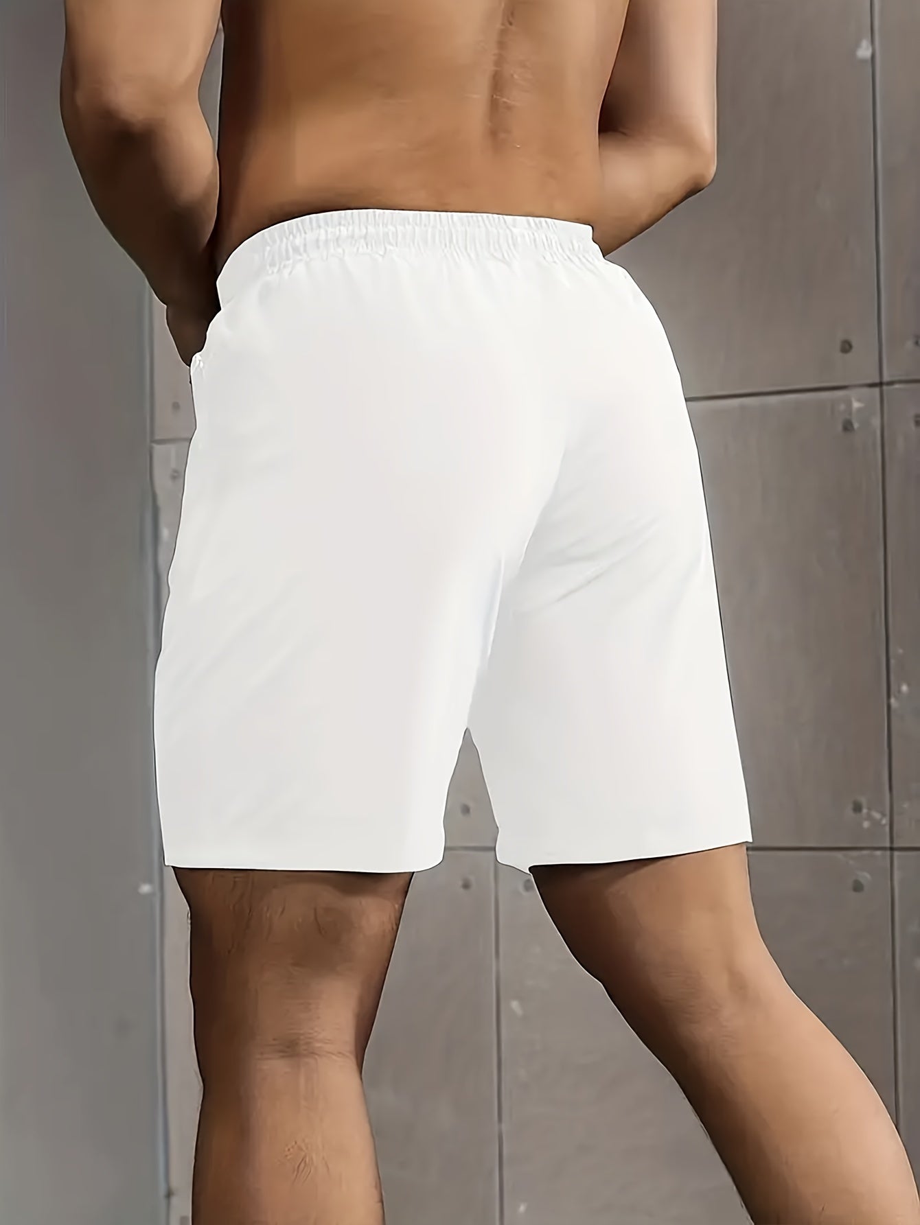 Solid men's shorts with zipper pockets, elastic waist drawstring for summer fitness.