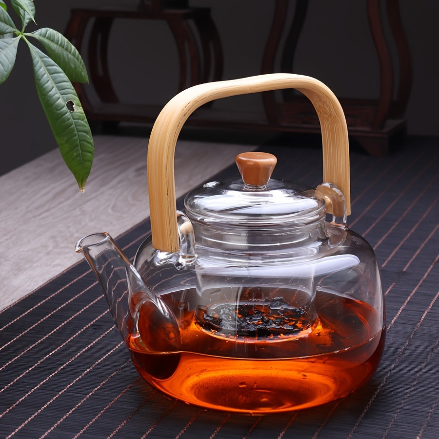 Stylish glass teapot with bamboo handle, ideal for blooming and loose leaf tea. Heat resistant and includes tea infuser. Perfect Christmas gift.