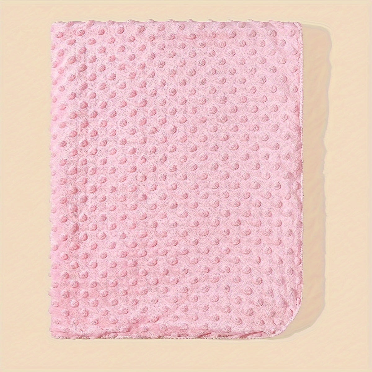 Soft polyester baby swaddle blanket featuring a woven pink, blue, and white dot pattern. This versatile infant wrap is perfect for all seasons and provides soothing comfort for your baby.