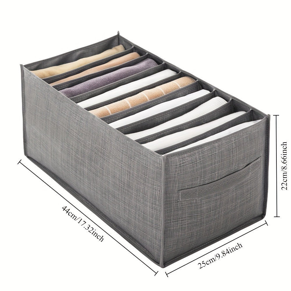 Compact gray storage box with multiple compartments for organizing clothing and books. Features reinforced edges and handle for easy portability. Perfect for small spaces.