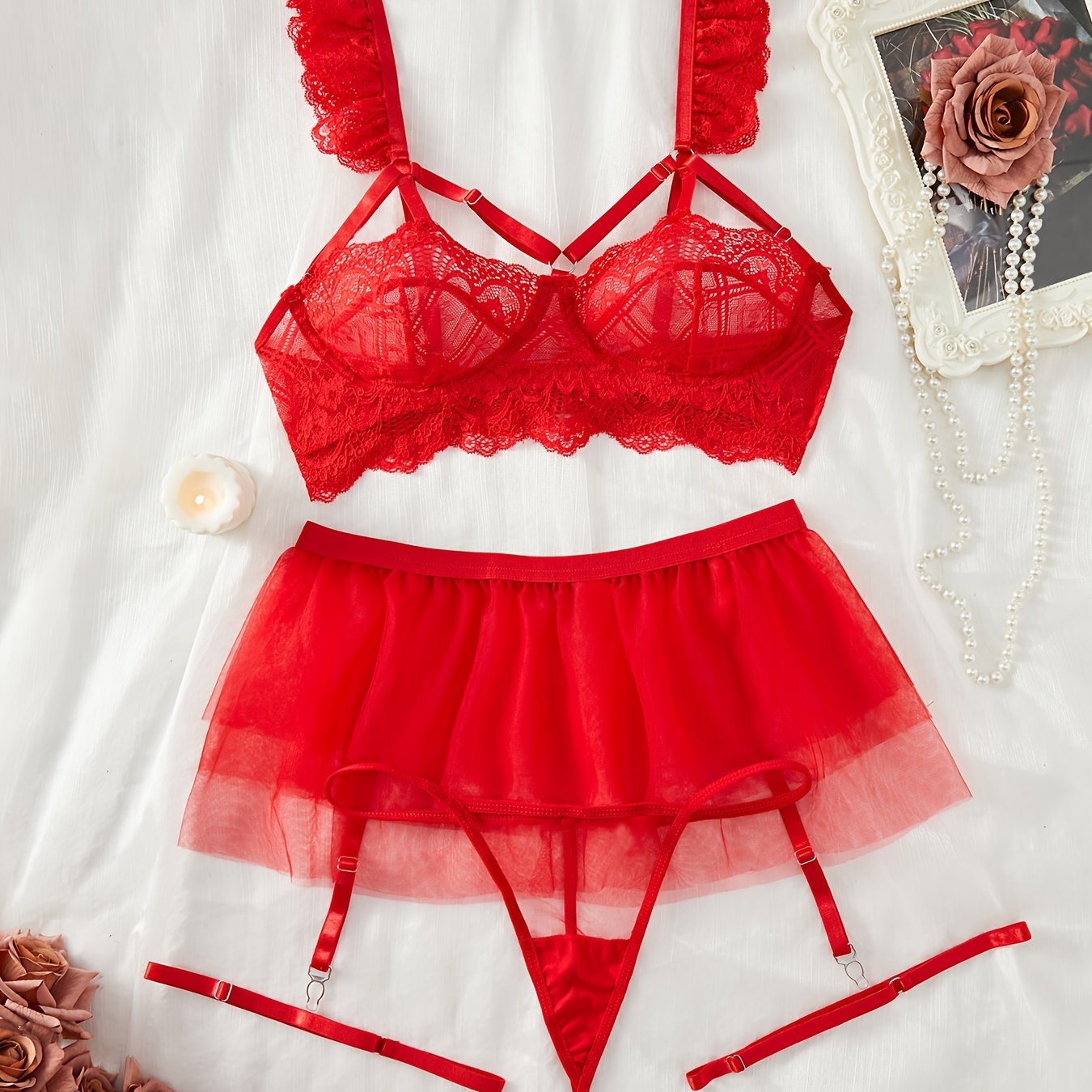 Red lace lingerie set with adjustable straps, mesh underwear, garter belt skirt, and leg garters, perfect for the bedroom.