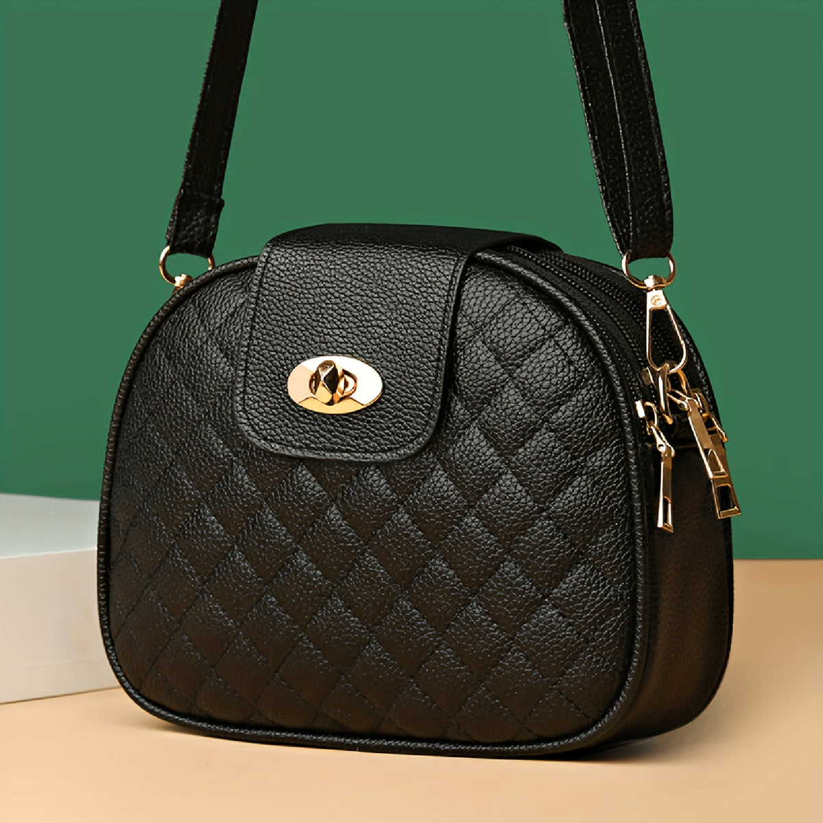 Women's faux leather crossbody bag with argyle quilted design, turn-lock closure, triple compartments, polyester lining, and adjustable strap for any occasion.