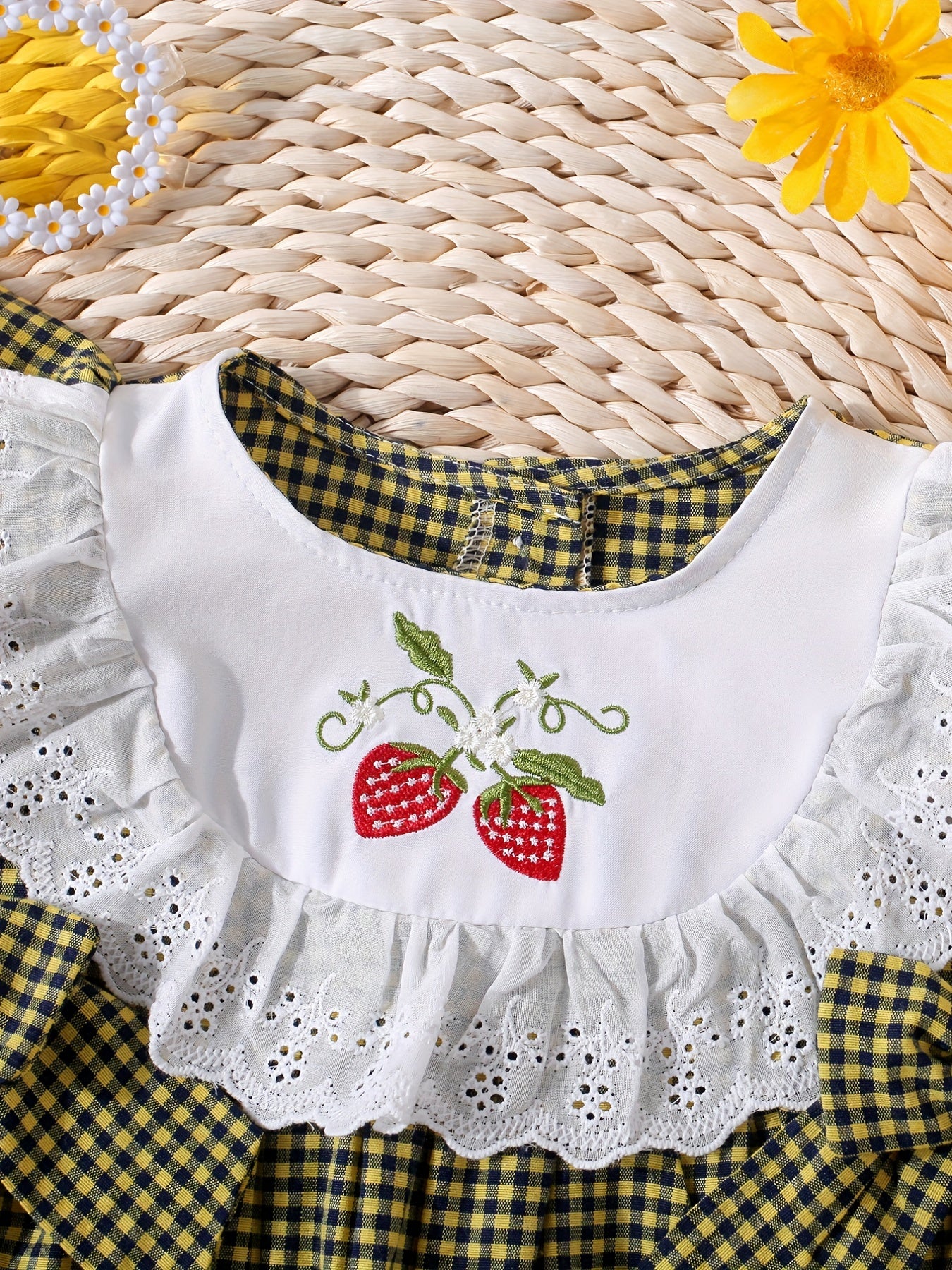 Infant girls' plaid onesie with strawberry embroidery and bow details, suitable for casual outdoor wear.