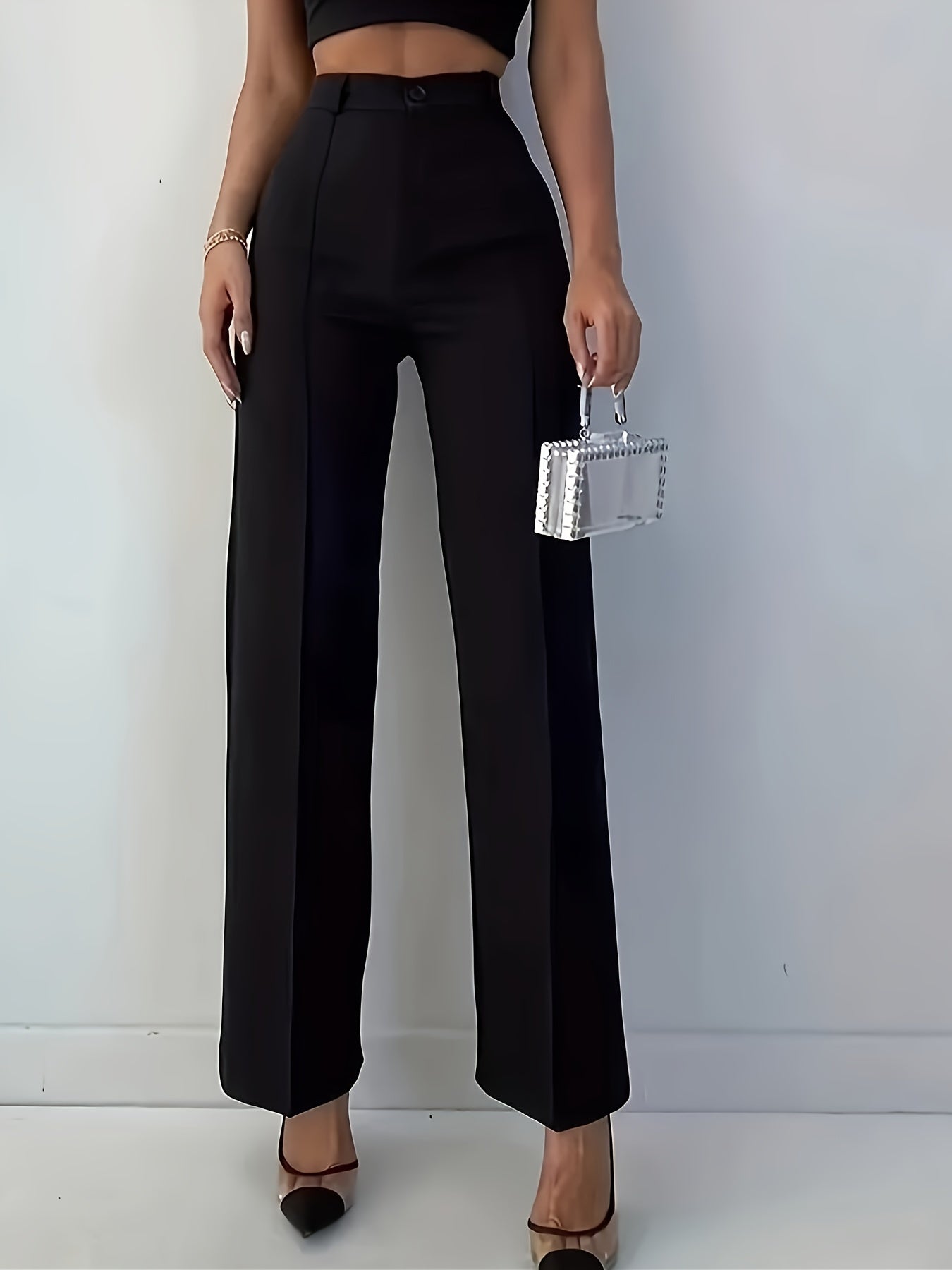 Stylish women's black pants, high-waisted, sleek polyester material, machine washable - suitable for professional and social occasions.