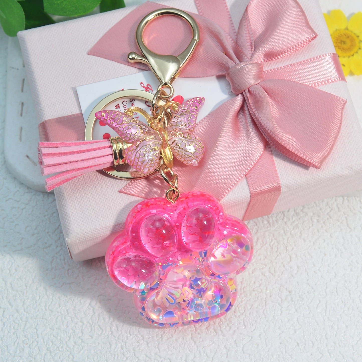 Butterfly tassel ladies bag keychain pendant in the shape of a cat's paw, perfect as a birthday or holiday gift for a creative animal lover.