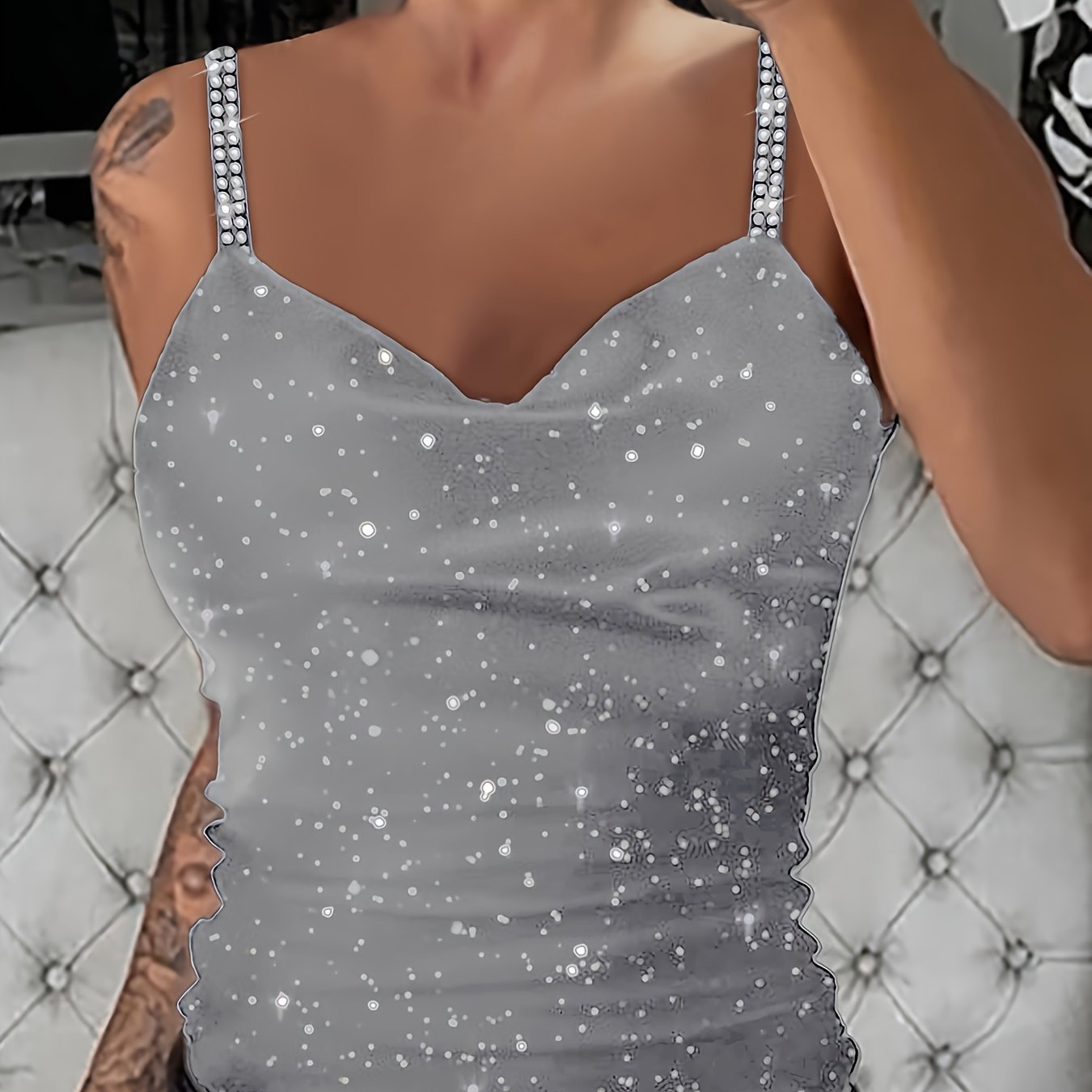 Sleek black sequin cami with rhinestone straps. V-neck, sleeveless, machine washable polyester knit. Stylish and sexy summer top.