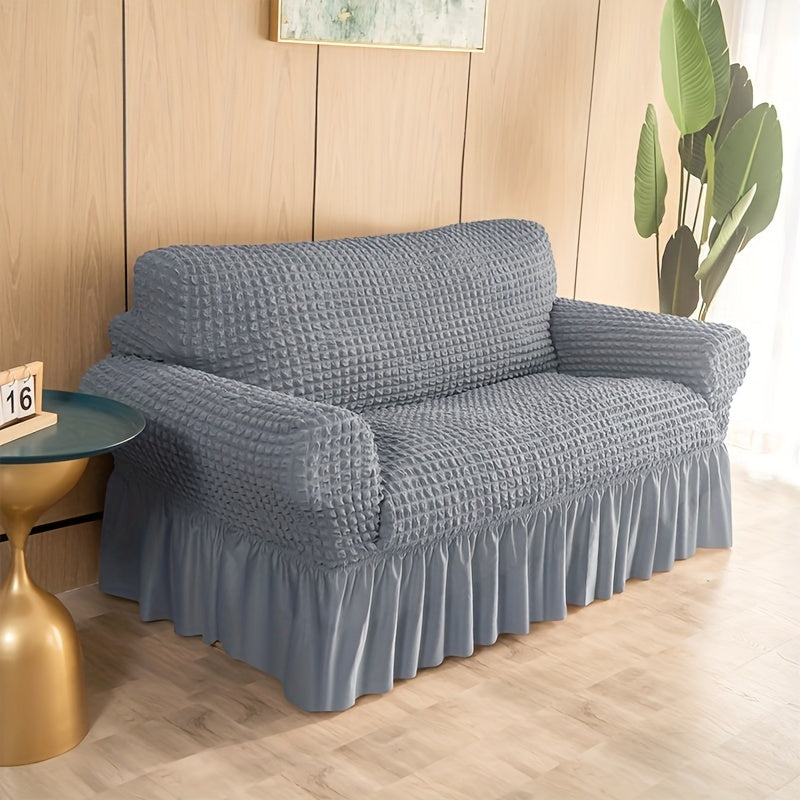 Non-slip elastic sofa cover with skirt for home decor.