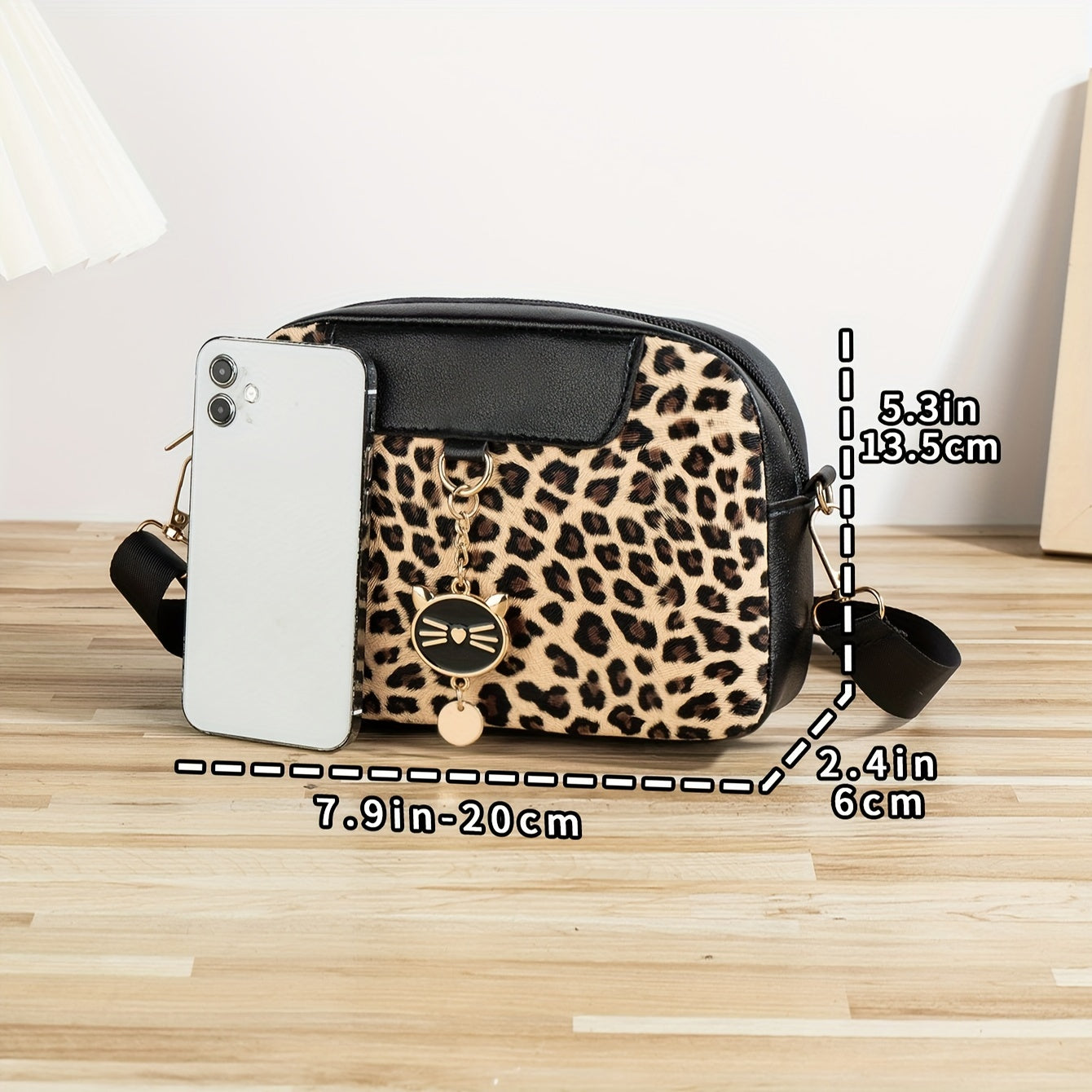 Chic leopard print crossbody bag with adjustable strap, cat charm, zip closure, and polyester lining - ideal for work, outings, and daily commutes.