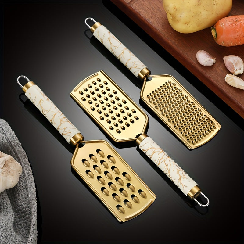 Stainless steel kitchen grater for shredding various foods, with a safe handle and luxurious golden appearance.