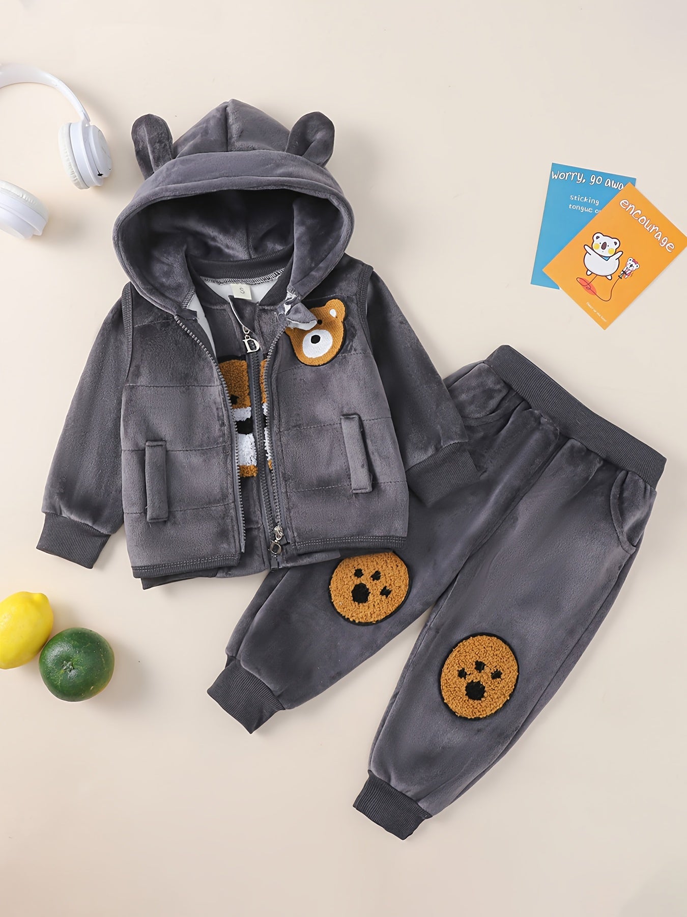 HIBOBI 3 piece toddler boy outfit set with bear appliqué top, hooded jacket, and pants made of 100% polyester with slight stretch. Regular fit for fall/winter and outdoor wear.