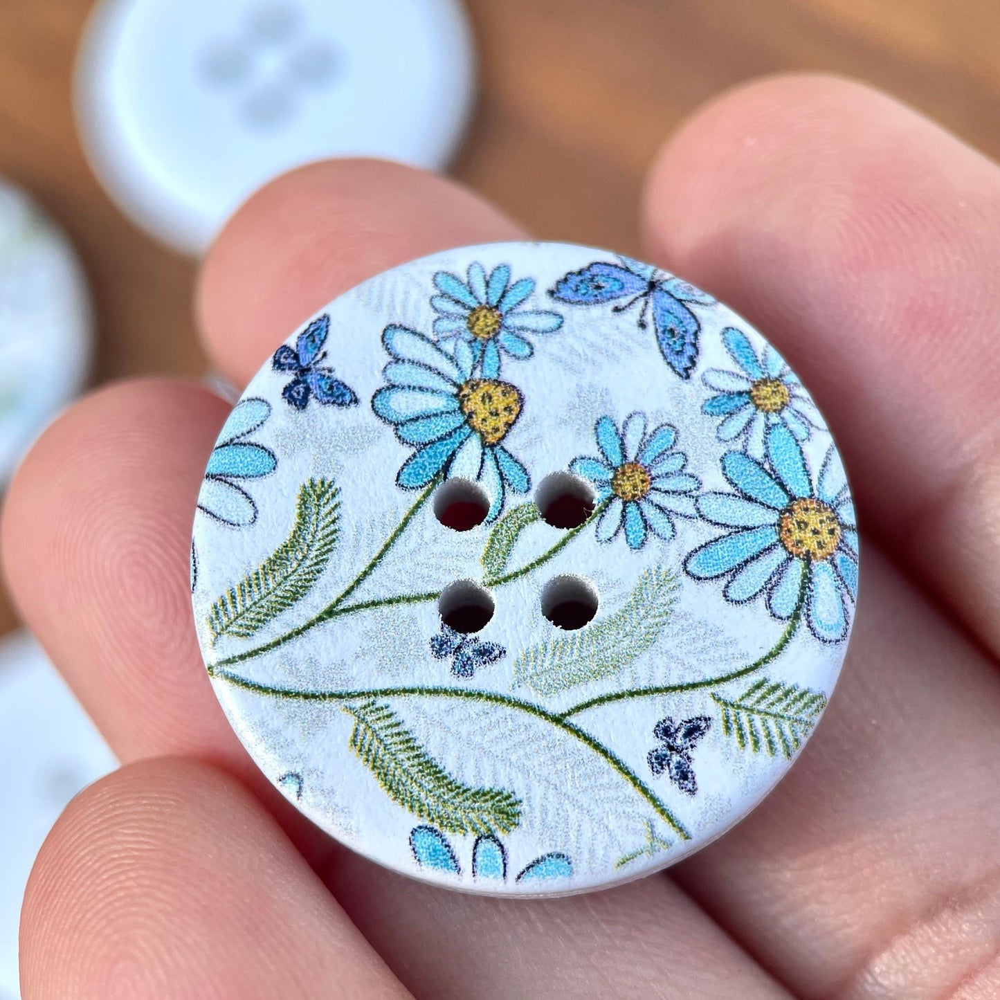 A set of 10 large decorative flower and butterfly buttons made of natural wood, each measuring 30mm in size and featuring 4 holes for sewing.