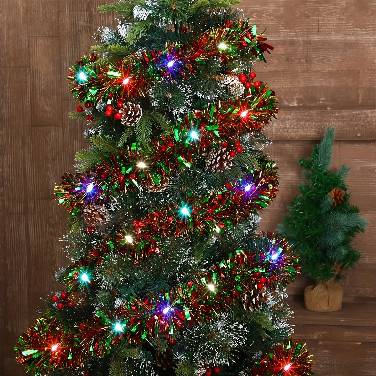 LED tinsel garland with lights, metallic shiny plastic Christmas tree decoration. Battery operated (2 AA not included). Thick hanging decor for Xmas party indoor. Sold as a 2-pack.