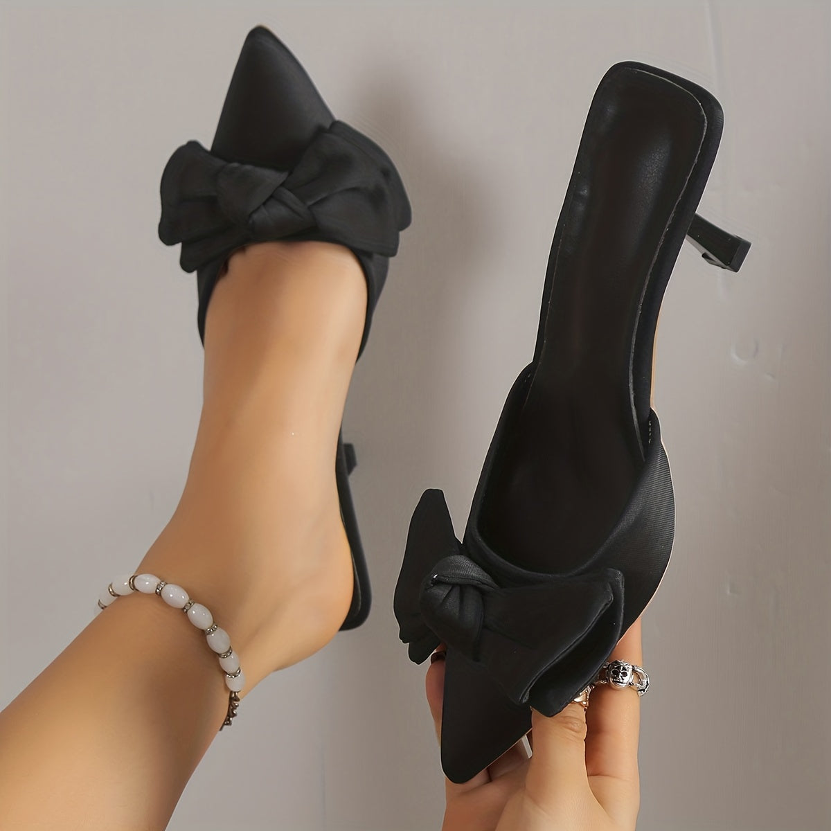 Women's bowknot design stiletto heel shoes with elegant slip-on style and pointed toe for summer dresses.