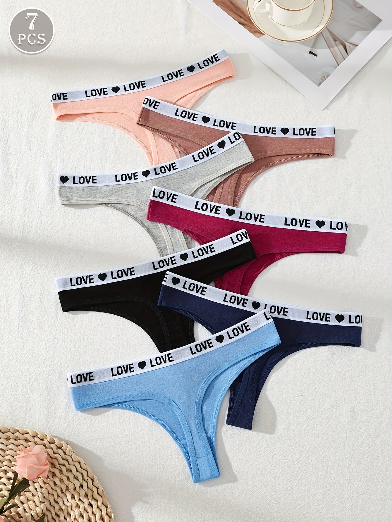 Seven sexy thong panties for women in solid color knit fabric with a drop waist, made of 95% elastane and 5% elastane for comfort fit.