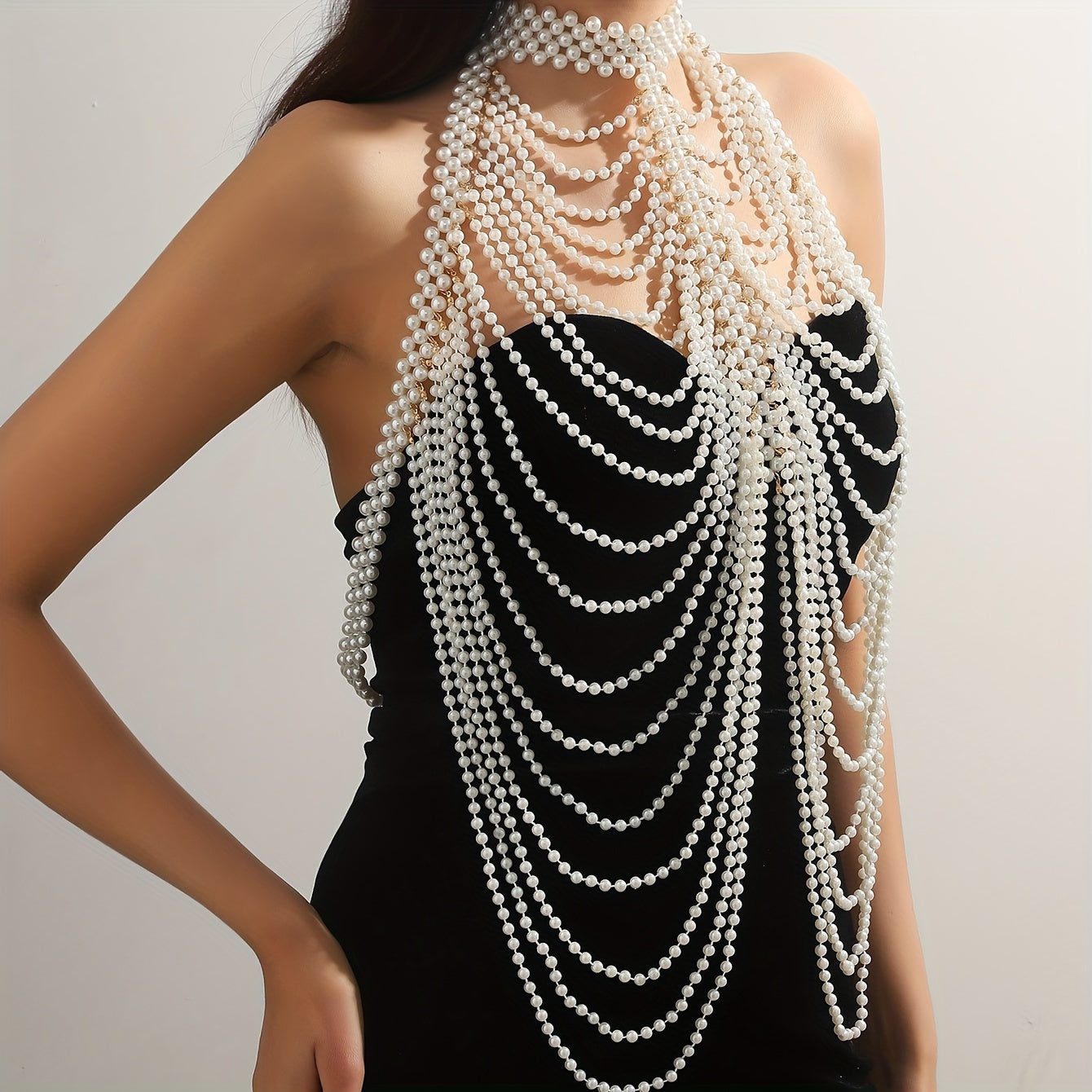 Luxurious and sexy, this female body chain features a creative design with exaggerated multi imitation pearl tassels, perfect for adding a touch of personality and style to any outfit.