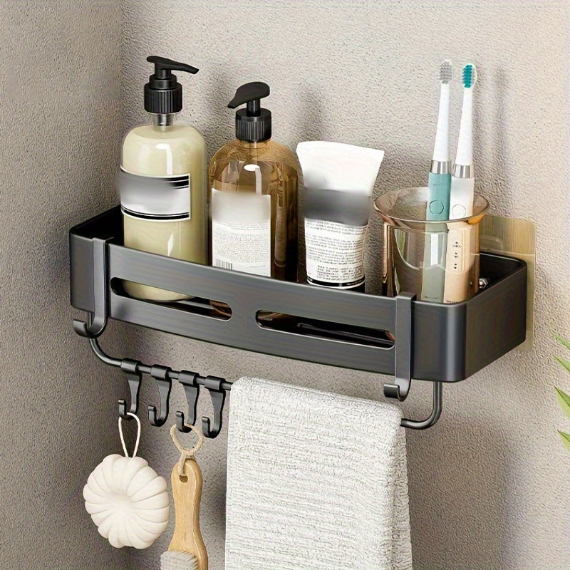 Wall-mounted bathroom storage rack for shampoo, shower gel, and cosmetics; made of space aluminum with no need for drilling.